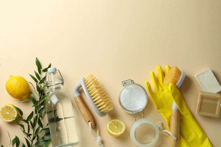 A variety of eco-friendly cleaning supplies arranged on a beige background, promoting sustainable carpet cleaning methods.